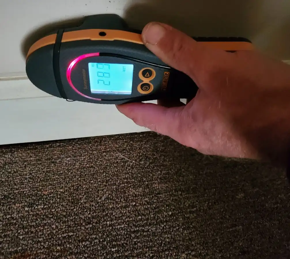 Moisture detection at baseboard during Storm Damage Restoration in Battlement Mesa